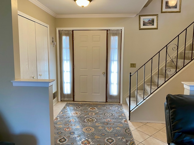 entryway with stairway, light tile patterned flooring, and crown molding