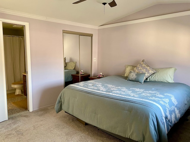 bedroom with lofted ceiling, ornamental molding, connected bathroom, light colored carpet, and ceiling fan