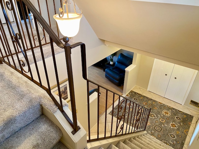 staircase featuring tile patterned floors