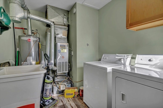 3034 Wolcott St, Ferndale, MI 48220 - washroom featuring a sink, wood finished floors, cabinet space, gas water heater, and washing machine and dryer