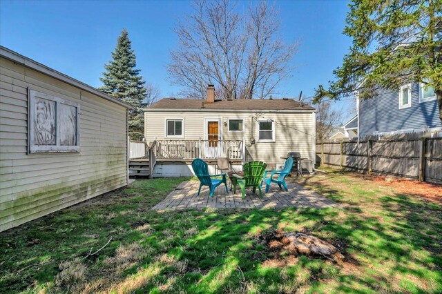 3034 Wolcott St, Ferndale, MI 48220 - rear view of house featuring fence, a patio, a lawn, and a wooden deck