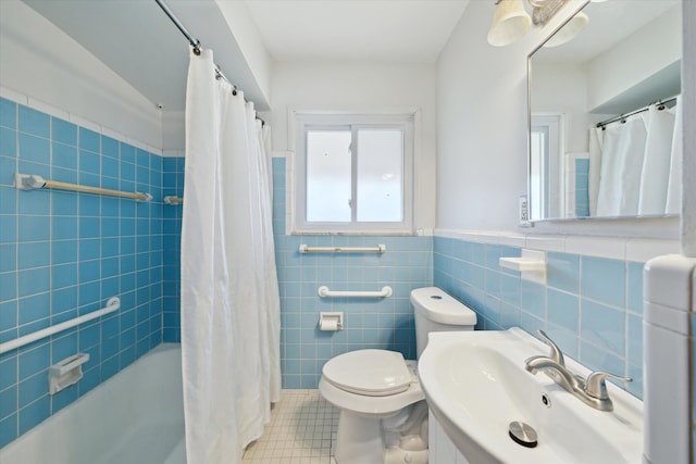 full bath featuring shower / tub combo, a sink, tile walls, toilet, and tile patterned flooring