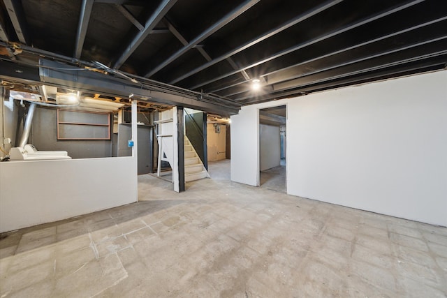 below grade area with stairway and washer and clothes dryer
