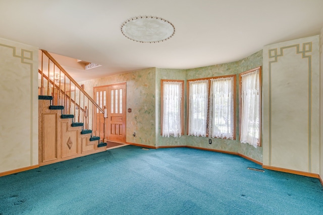 interior space featuring stairs, baseboards, visible vents, and carpet