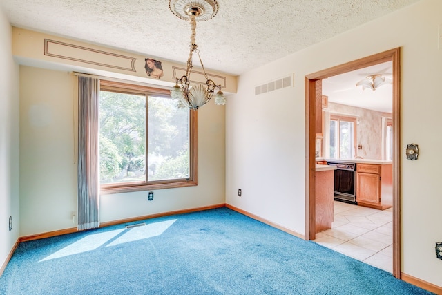 empty room featuring baseboards, light colored carpet, and visible vents