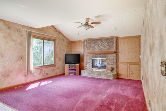 unfurnished living room featuring carpet floors, a ceiling fan, a brick fireplace, and lofted ceiling