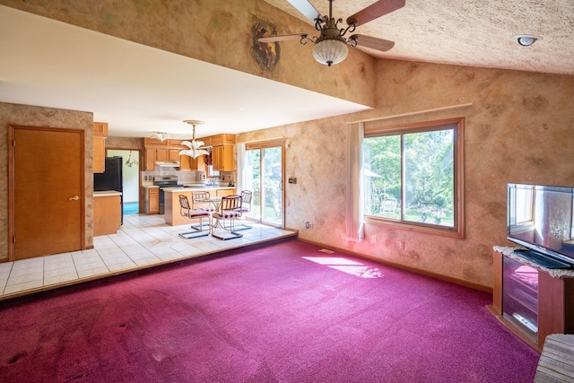 unfurnished living room featuring light colored carpet, ceiling fan, vaulted ceiling, and baseboards