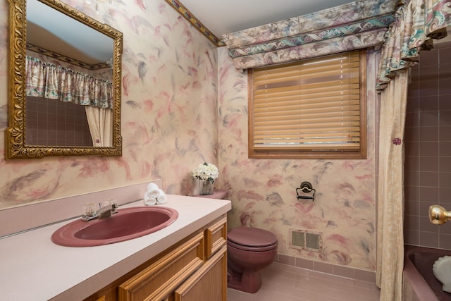 bathroom with vanity, toilet, tile patterned floors, wallpapered walls, and visible vents