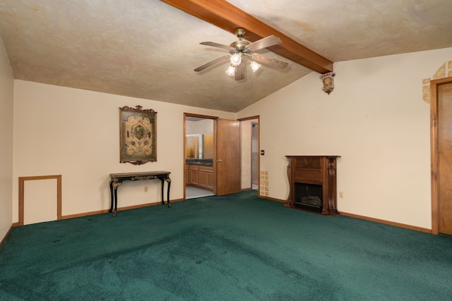 unfurnished living room featuring a fireplace with raised hearth, ceiling fan, vaulted ceiling with beams, and carpet