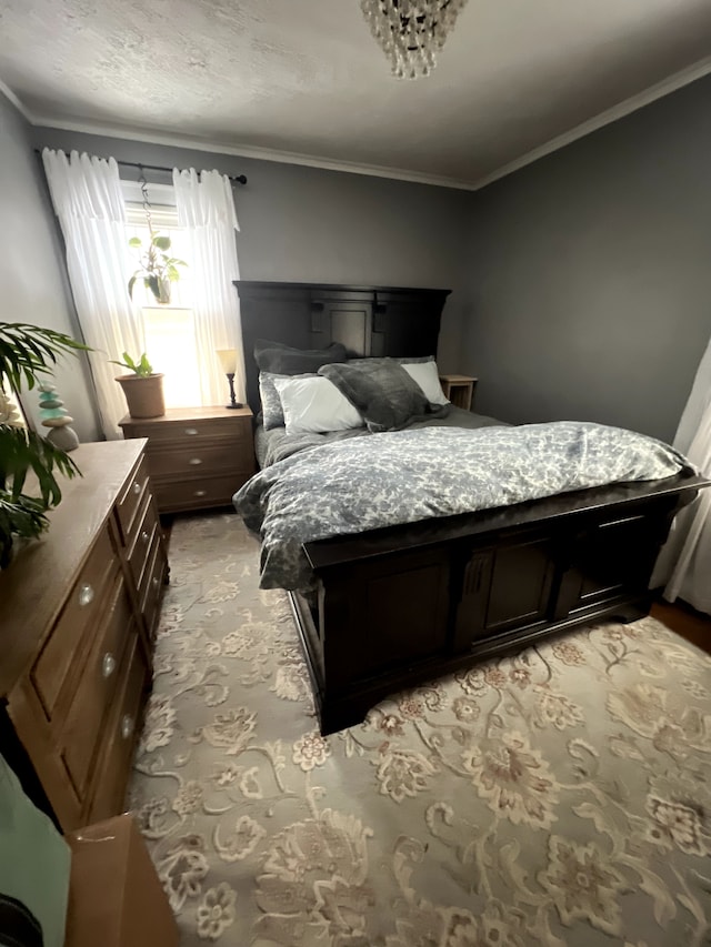 bedroom with ornamental molding and light carpet