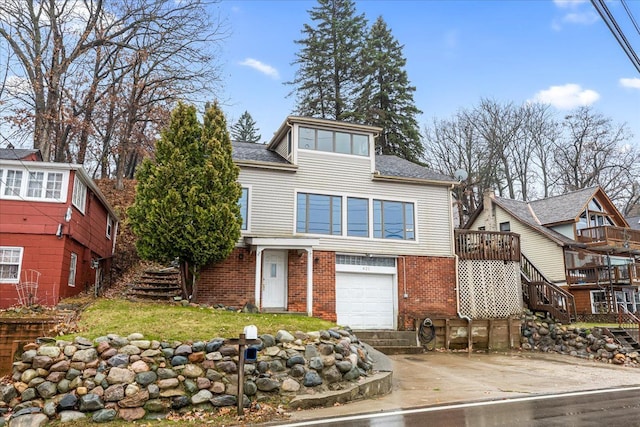 423 Heights Rd, Lake Orion, MI 48362 - view of front facade with driveway, an attached garage, stairway, and brick siding