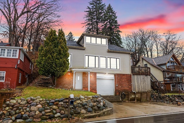 423 Heights Rd, Lake Orion, MI 48362 - view of front of house with stairs, a garage, driveway, and brick siding