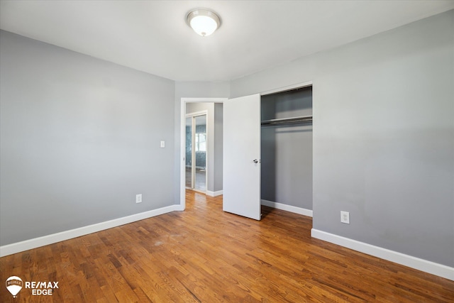 3738 Holly Ave, Flint, MI 48506 - unfurnished bedroom featuring a closet and wood finished floors