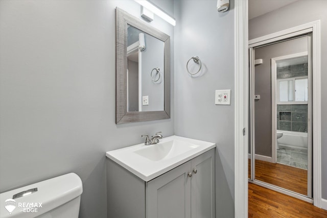 3738 Holly Ave, Flint, MI 48506 - bathroom with vanity, wood finished floors, and a tub to relax in