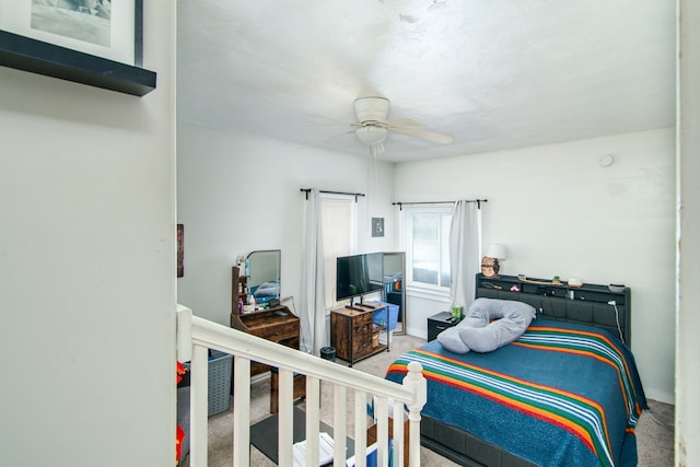 bedroom with baseboards, a ceiling fan, and carpet