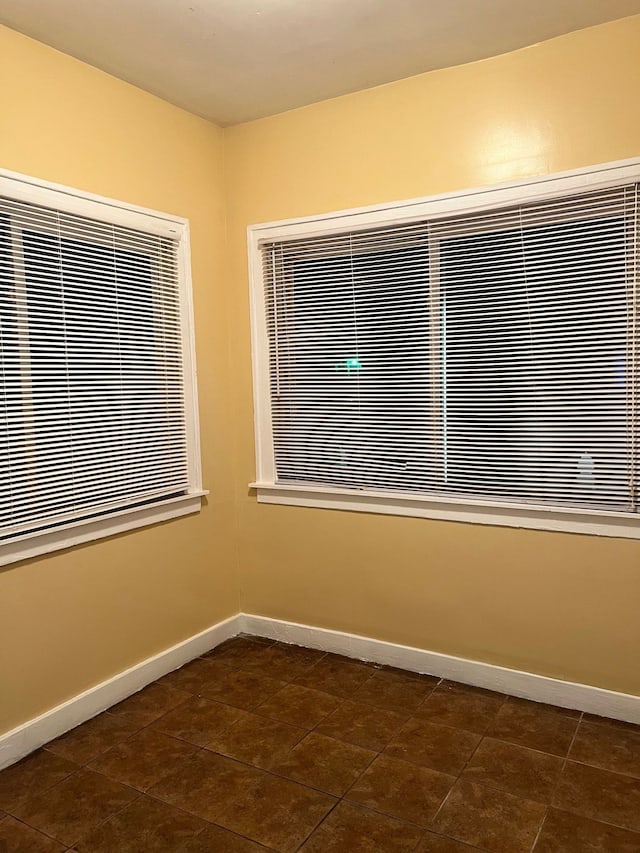 8451 La Salle Blvd, Detroit, MI 48206 - empty room featuring dark tile patterned flooring and baseboards