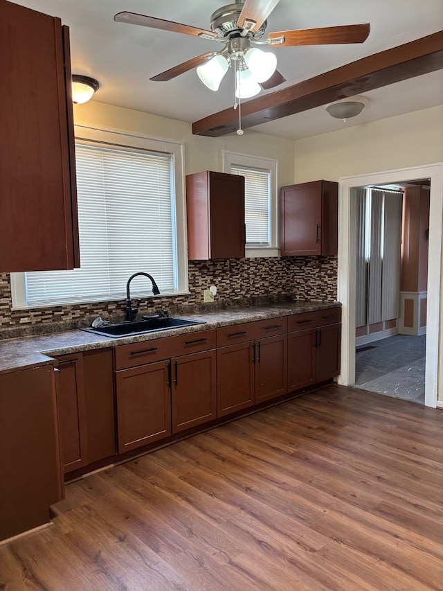 8451 La Salle Blvd, Detroit, MI 48206 - kitchen featuring backsplash, a sink, dark countertops, and dark wood-type flooring