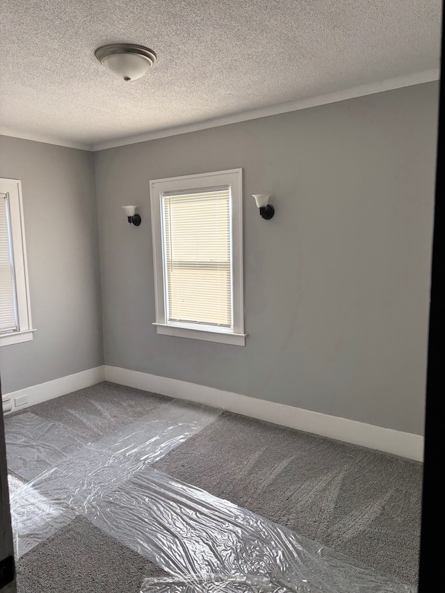 8451 La Salle Blvd, Detroit, MI 48206 - empty room with baseboards, carpet floors, and a textured ceiling