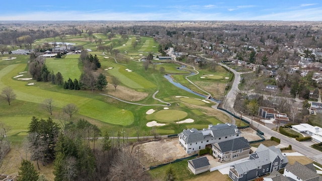 view of property location with a nearby body of water, a local golf course, and nearby suburban area