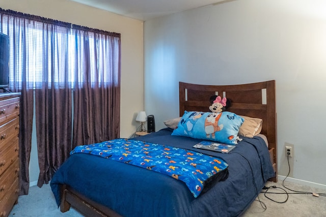 carpeted bedroom with baseboards