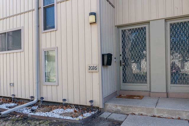 view of exterior entry featuring board and batten siding