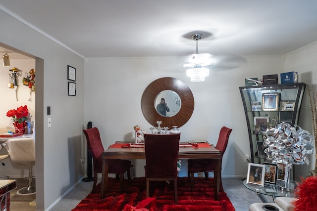 dining room with ornamental molding, baseboards, and ceiling fan