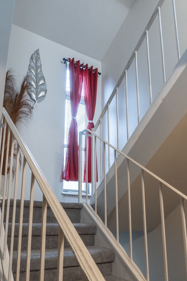 staircase with a towering ceiling