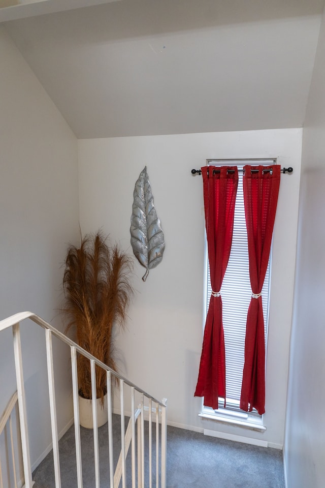 staircase with baseboards and carpet