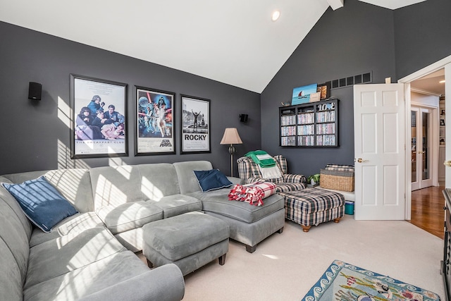 1615 Royal Birkdale Dr, Oxford, MI 48371 - living room featuring visible vents, high vaulted ceiling, beam ceiling, and carpet