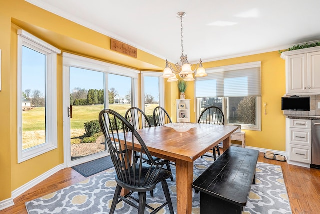 1615 Royal Birkdale Dr, Oxford, MI 48371 - dining space with baseboards, ornamental molding, wood finished floors, and a chandelier