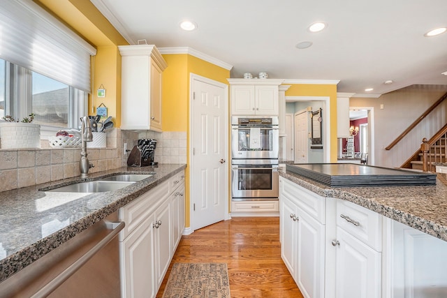 1615 Royal Birkdale Dr, Oxford, MI 48371 - kitchen with a sink, stainless steel appliances, a healthy amount of sunlight, and light wood-type flooring
