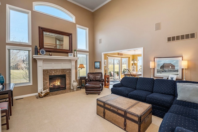 1615 Royal Birkdale Dr, Oxford, MI 48371 - carpeted living room with crown molding, baseboards, a high ceiling, visible vents, and a high end fireplace
