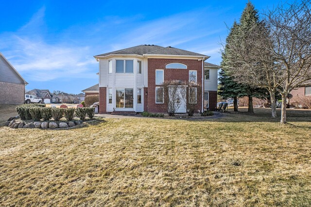 1615 Royal Birkdale Dr, Oxford, MI 48371 - back of property featuring brick siding and a lawn