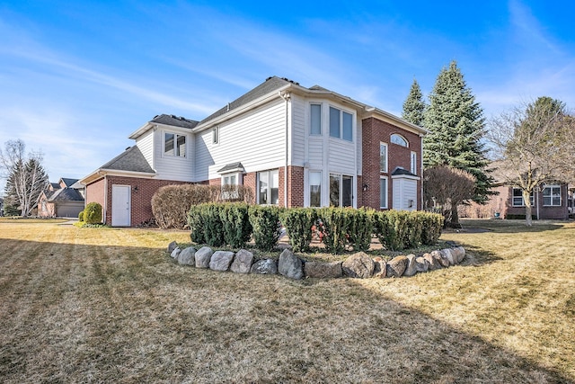 1615 Royal Birkdale Dr, Oxford, MI 48371 - view of side of home featuring a lawn and brick siding