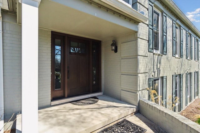 property entrance with brick siding