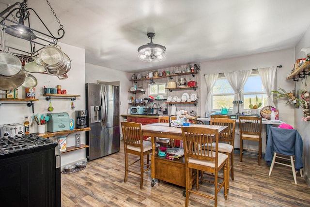 771 Q Dr S, Fulton, MI 49052 - dining area featuring light wood finished floors and a chandelier