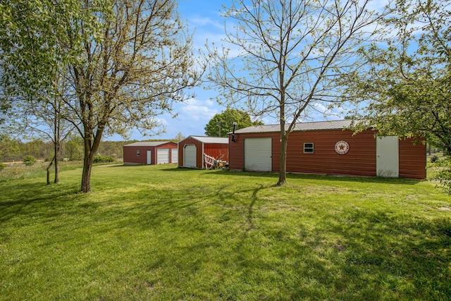 771 Q Dr S, Fulton, MI 49052 - view of green lawn featuring a detached garage and an outbuilding