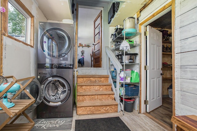 771 Q Dr S, Fulton, MI 49052 - laundry room with stacked washer and clothes dryer and wood finished floors