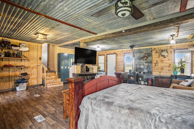 771 Q Dr S, Fulton, MI 49052 - bedroom with wood walls, a wood stove, and wood-type flooring