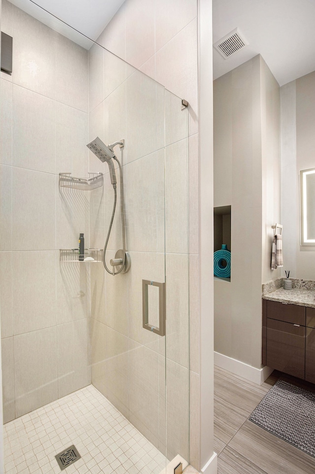 1686 Traceky, Rochester Hills, MI 48306 - bathroom featuring a shower stall, vanity, and baseboards