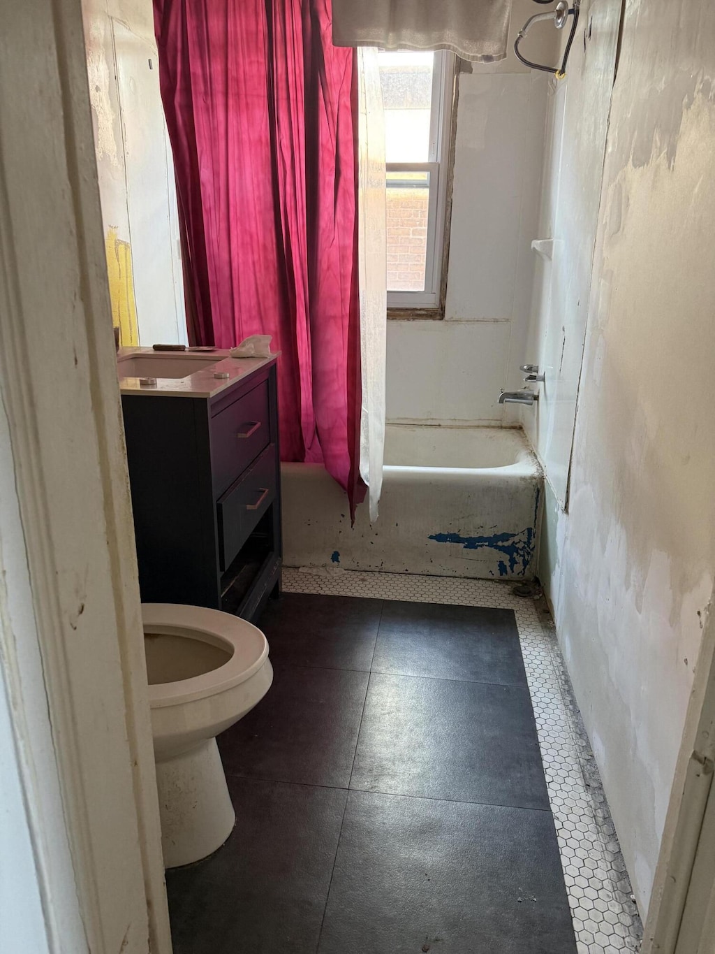 full bathroom featuring toilet, vanity, and washtub / shower combination