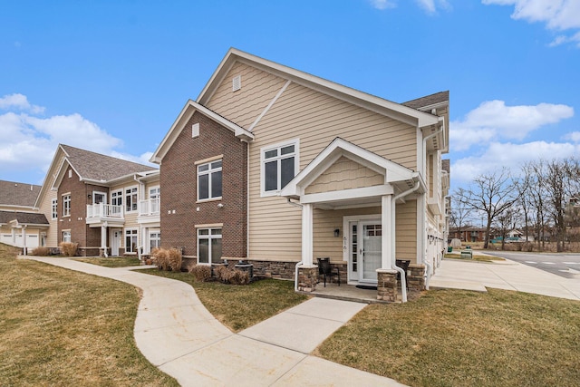 616 Boardwalk Ln Unit 24, Dexter, MI 48130 - view of front of home with stone siding and a front lawn