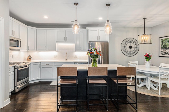 616 Boardwalk Ln Unit 24, Dexter, MI 48130 - kitchen featuring light countertops, a chandelier, stainless steel appliances, dark wood-type flooring, and a sink