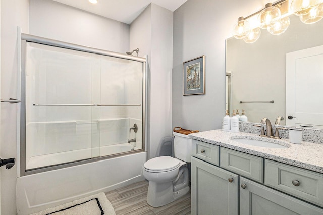 616 Boardwalk Ln Unit 24, Dexter, MI 48130 - full bathroom with combined bath / shower with glass door, wood finished floors, toilet, and vanity