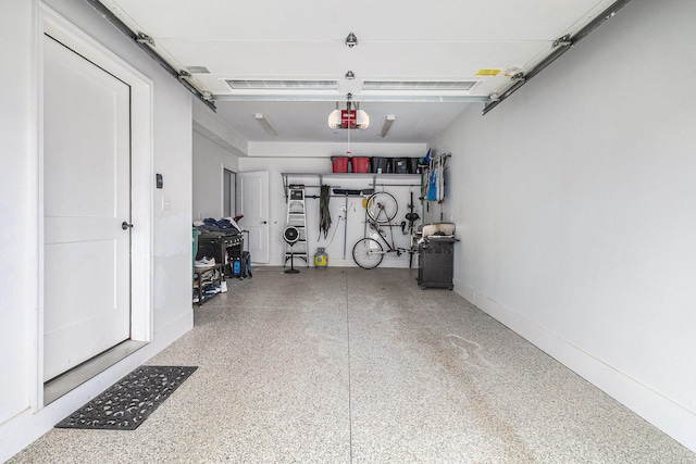 616 Boardwalk Ln Unit 24, Dexter, MI 48130 - garage with baseboards and a garage door opener