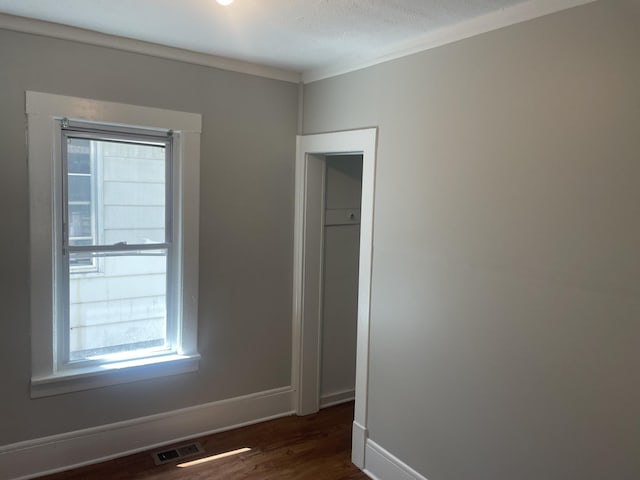 1776 Mcilwrath St, Muskegon, MI 49442 - spare room with plenty of natural light, dark wood-style flooring, and baseboards