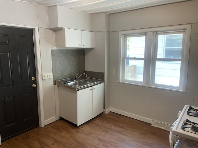 1776 Mcilwrath St, Muskegon, MI 49442 - kitchen with a sink, dark wood-style floors, white cabinetry, white range with gas stovetop, and dark countertops