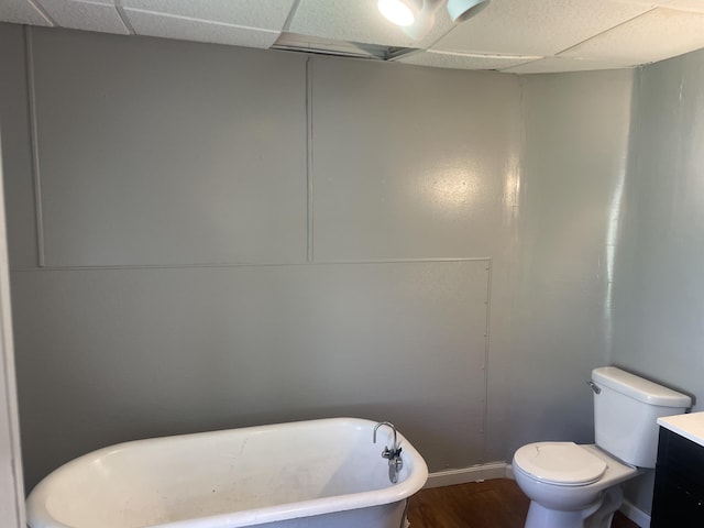 1776 Mcilwrath St, Muskegon, MI 49442 - bathroom featuring a freestanding tub, wood finished floors, toilet, baseboards, and vanity
