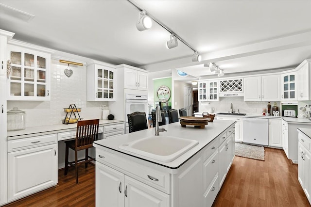 2865 Steeple Hill Rd, White Lake, MI 48383 - kitchen featuring a sink, white appliances, a kitchen island with sink, backsplash, and white cabinets