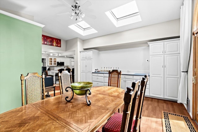 2865 Steeple Hill Rd, White Lake, MI 48383 - dining room with a skylight, wood finished floors, lofted ceiling, and a ceiling fan
